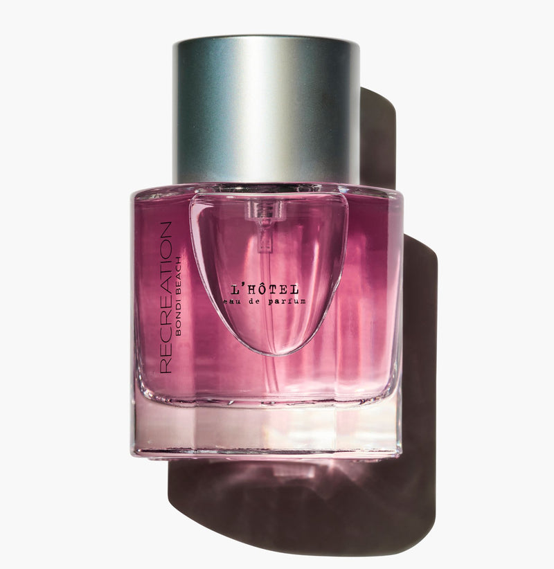 Pink perfume bottle with silver cap on a white background